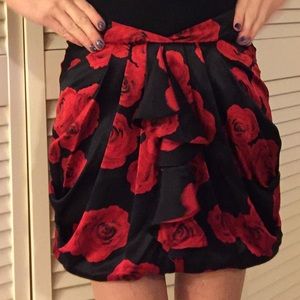 Bebe black mini skirt with red roses